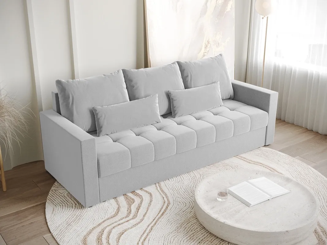 Szara kanapa z neutralnymi ścianami inspiracje