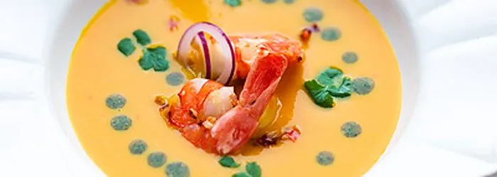 Zupa dyniowa z krewetkami i świeżą kolendrą, skropiona oliwą