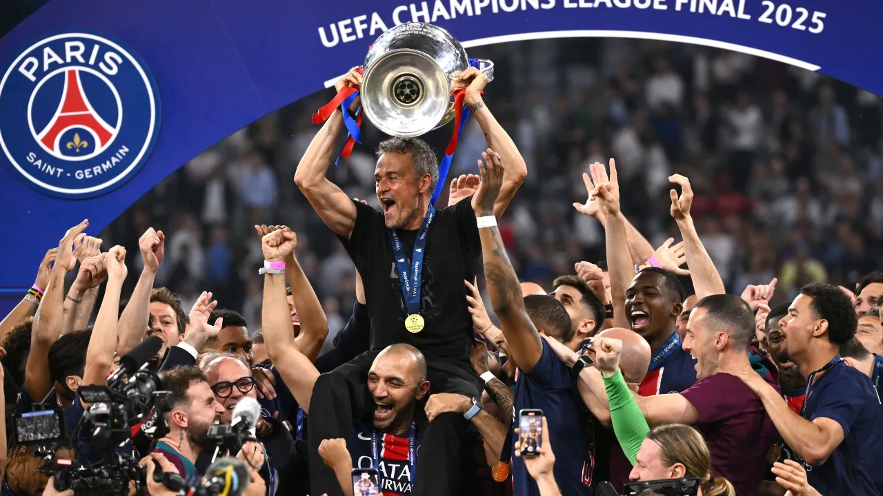 PSG świętuje zwycięstwo w Lidze Mistrz&oacute;w 2025! Trener Luis Enrique niesie puchar, otoczony przez radosnych zawodnik&oacute;w i kibic&oacute;w.