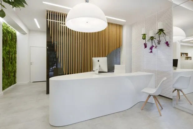 nowoczesny gabinet stomatologiczny z uśmiechniętym dentystą