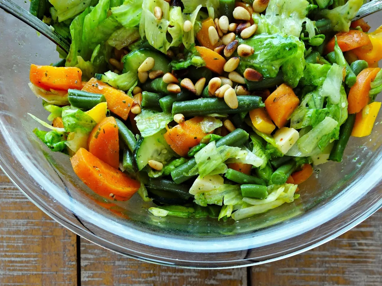 Kolorowa sałatka z fasolką szparagową, marchewką i orzeszkami pinii. Idealna na lato, gdy zastanawiasz się, jak długo gotować warzywa na sałatkę, by były chrupiące.