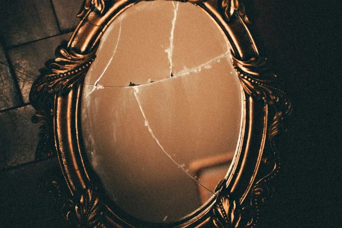 Symboliczne zdjęcie: osoba patrząca w lustro z zniekształconym obrazem siebie