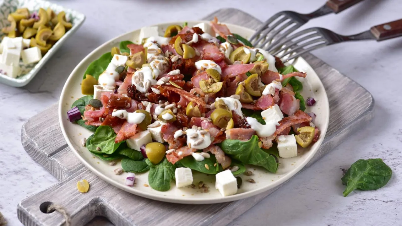 Pyszna sałatka ze szpinakiem, fetą, oliwkami, suszonymi pomidorami i chrupiącym słonecznikiem.