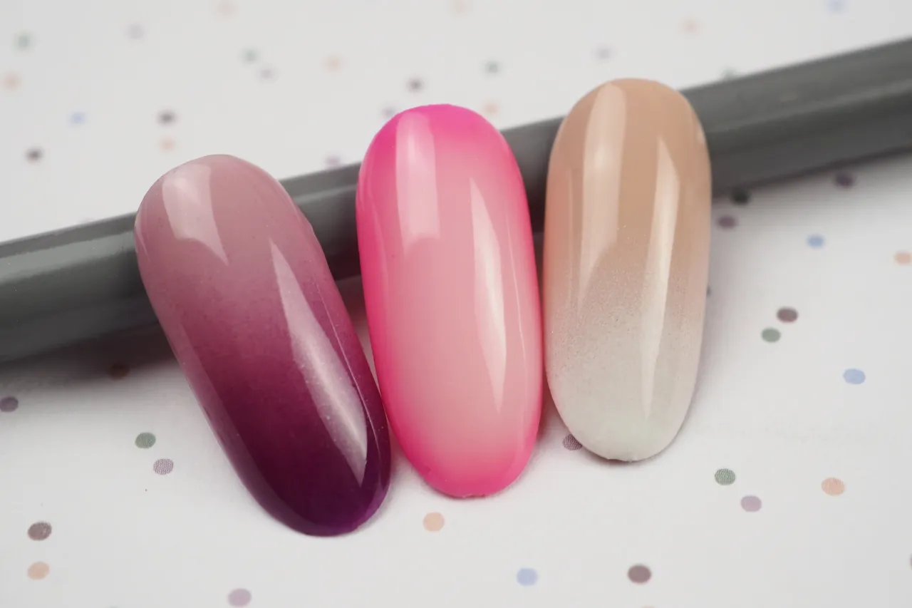 Trzy wzorniki paznokci z efektem ombre: fioletowo-różowy, intensywnie różowy i beżowo-biały.