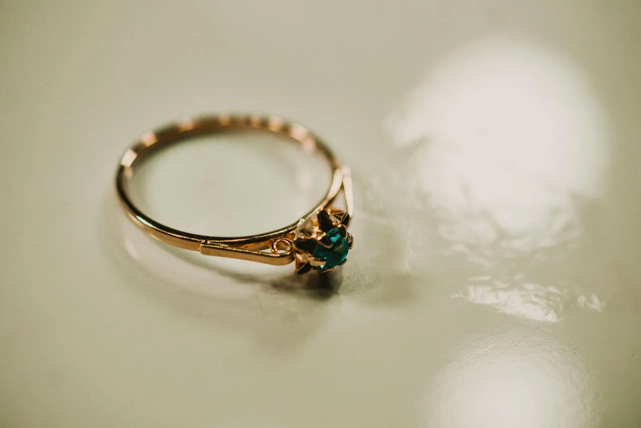 Ręce czyszczące złoty pierścionek w misce