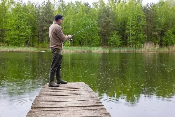 Wędkarz łowiący w deszczu lub pochmurny dzień