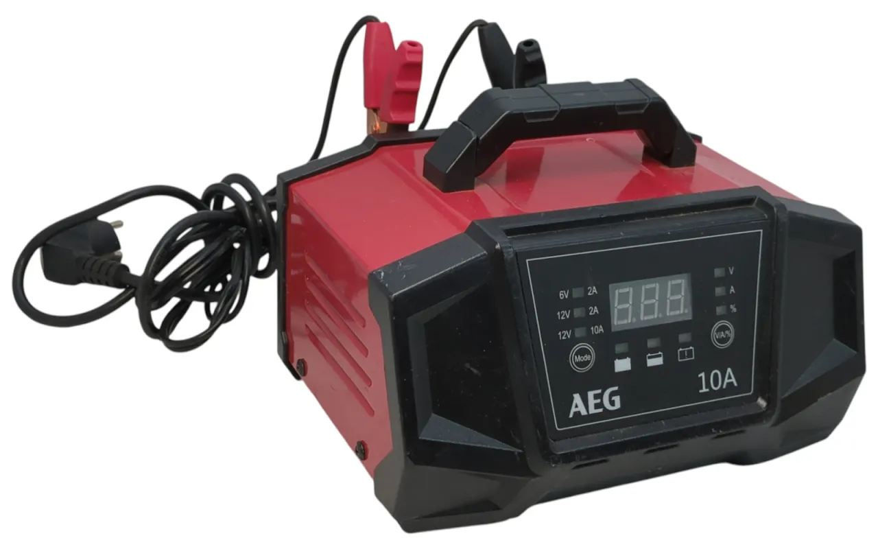 Czerwony prostownik AEG z cyfrowym wyświetlaczem i kablem zasilającym. Widać zaciski do akumulatora.