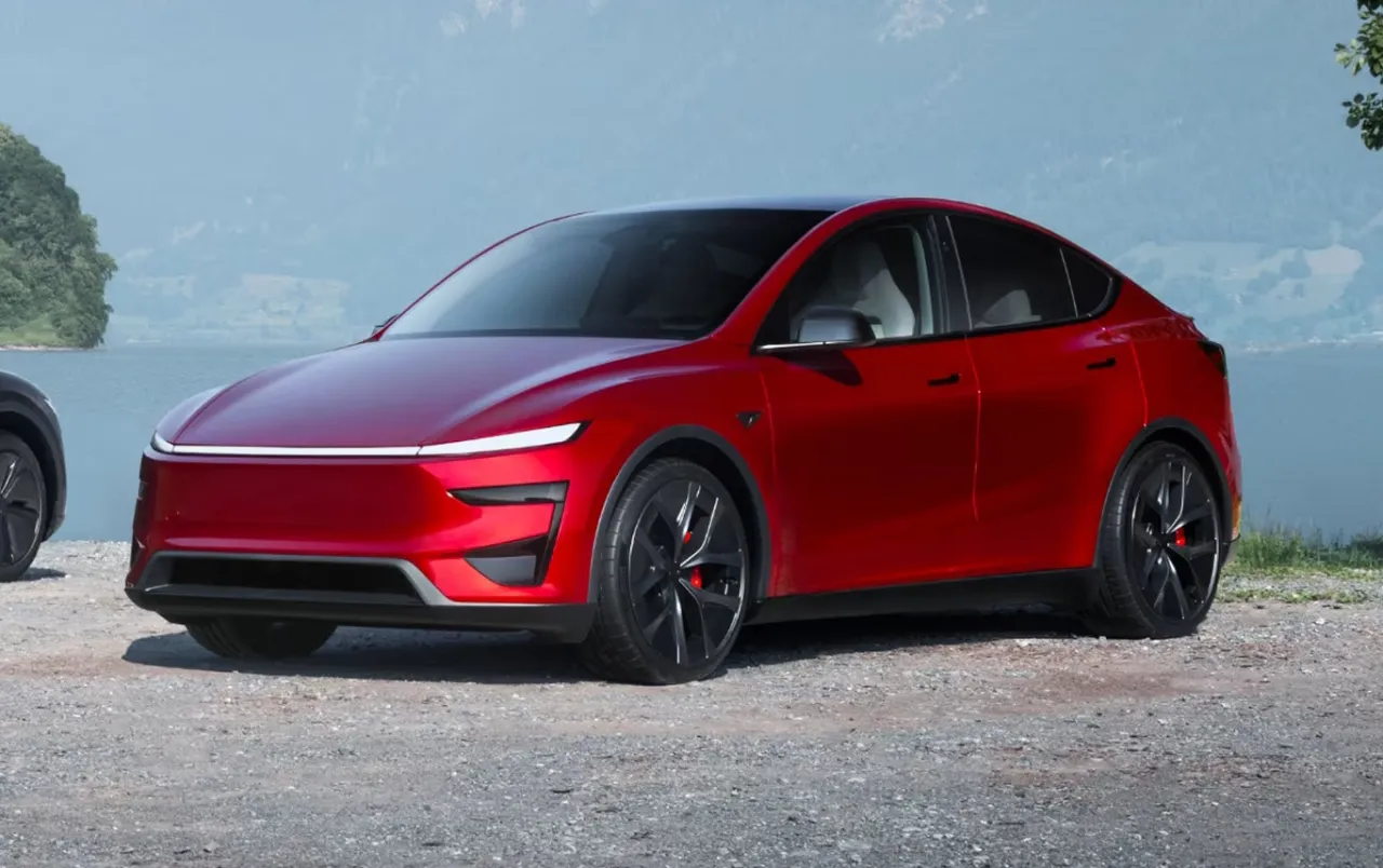 Czerwony Tesla Y z imponującą mocą, kt&oacute;ra dor&oacute;wnuje wielu koniom, zaparkowany nad jeziorem.