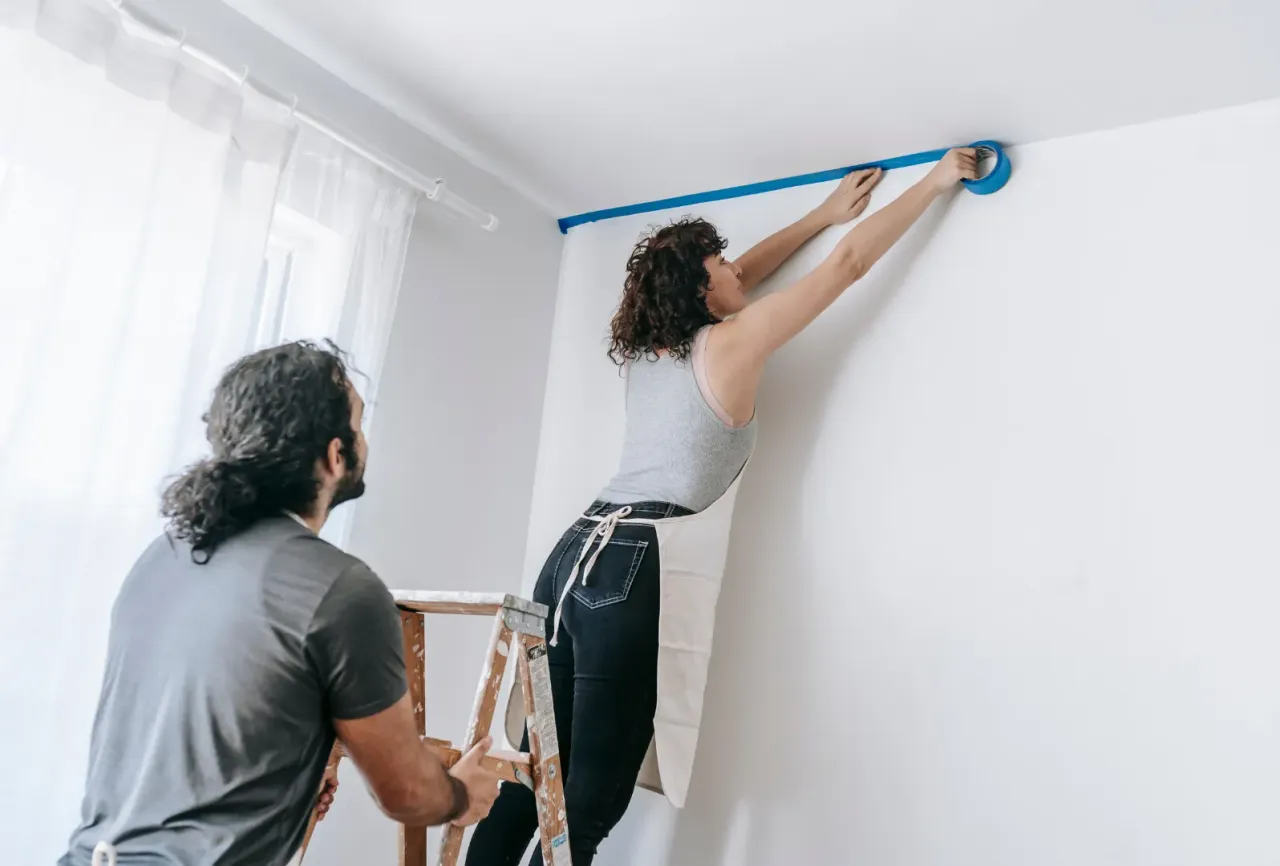 Malowanie ściany przy suficie taśmą malarską