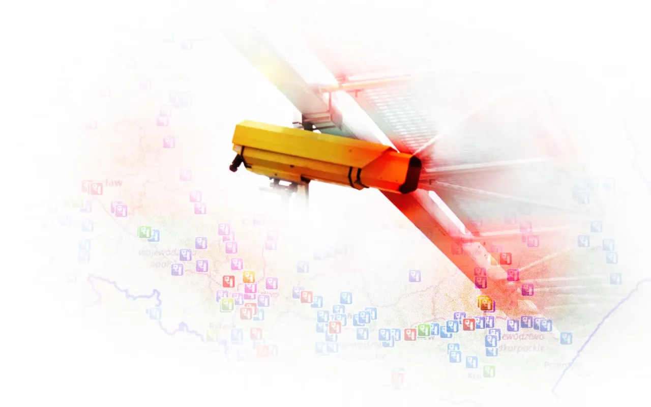 Żółta kamera monitorująca, gdzie są kamery rejestrujące przejazd na czerwonym świetle, nad mapą z zaznaczonymi punktami kontrolnymi.