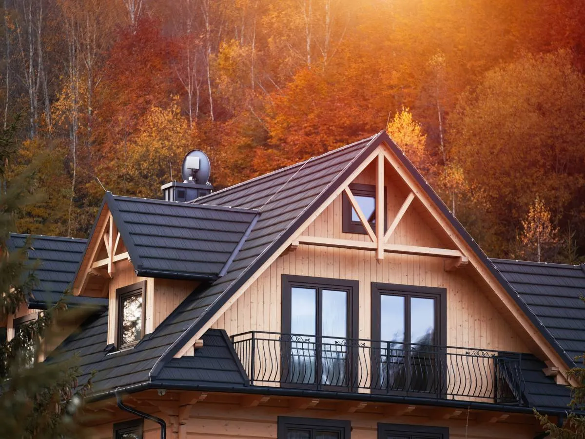 Piękny drewniany domek letniskowy w jesiennej scenerii. Marzysz o własnym? Dowiedz się, jak dostać dofinansowanie na domki letniskowe.