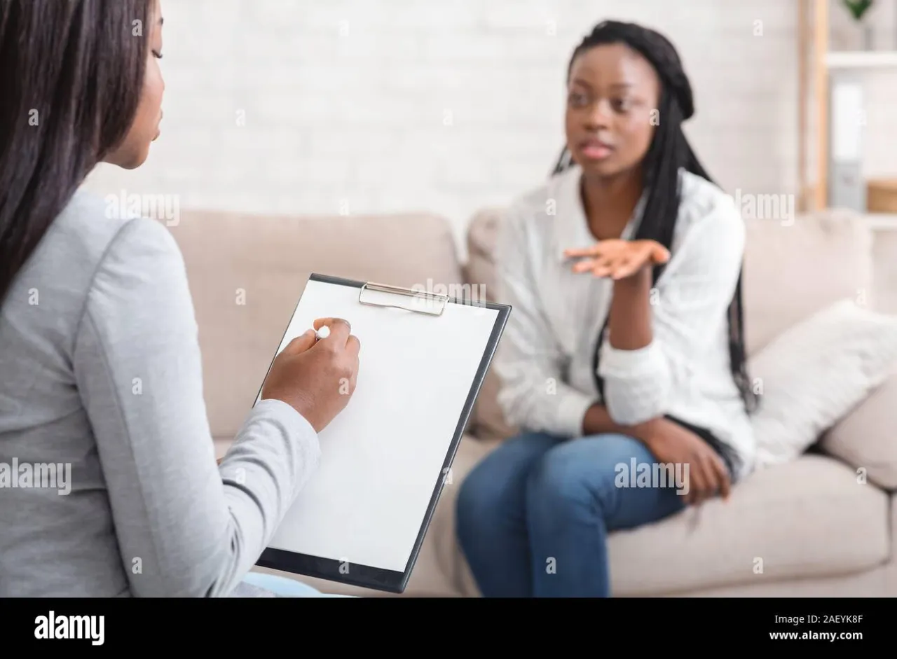 psychologist talking with a client during therapy session