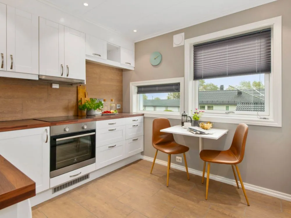 biała kuchnia z drewnianym blatem aranżacje