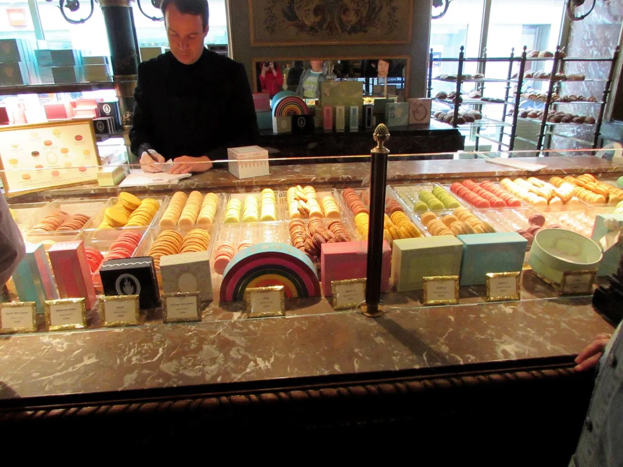 Kolorowe makaroniki i inne słodkości w paryskiej cukierni. Idealne, by dowiedzieć się, co kupić w Paryżu na pamiątkę.