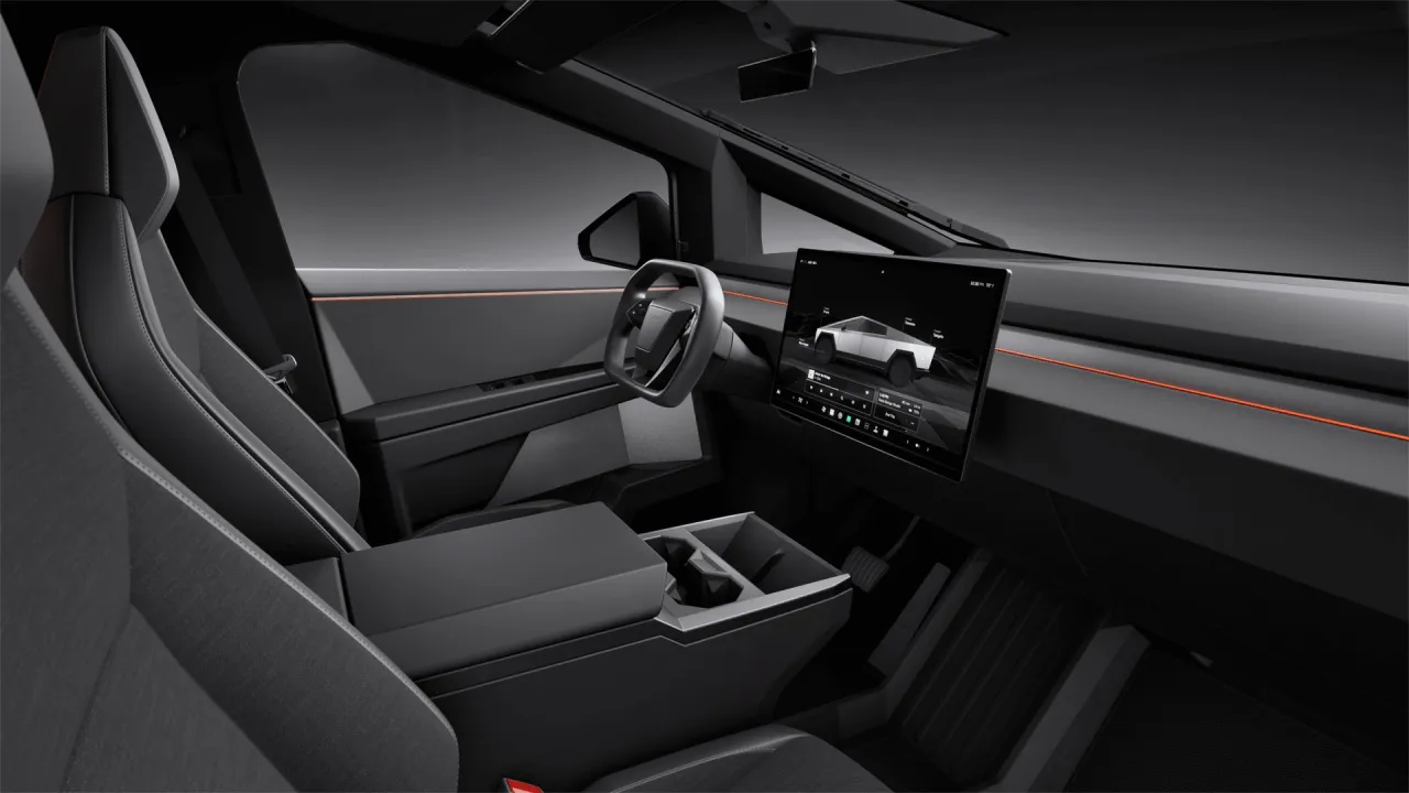 Wnętrze Tesli Cybertruck: minimalistyczne, z dużym ekranem dotykowym, futurystyczną kierownicą i wygodnymi fotelami.