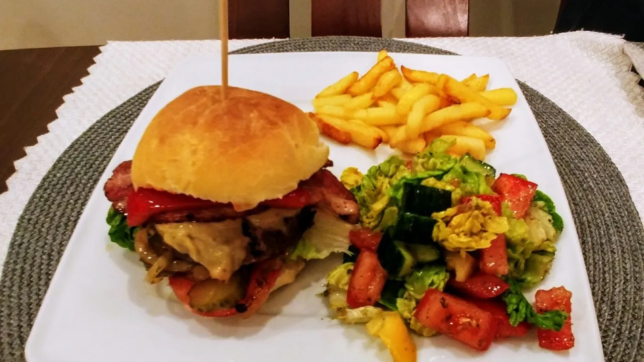 soczysty domowy burger wołowy z serem i warzywami z bliska