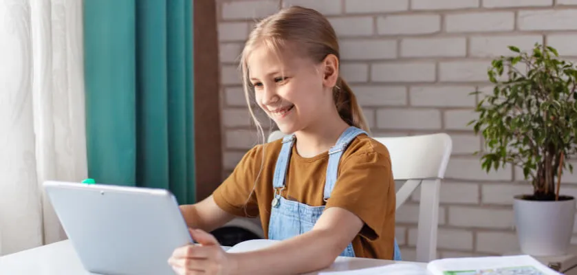 młoda osoba używająca laptopa i tabletu do nauki