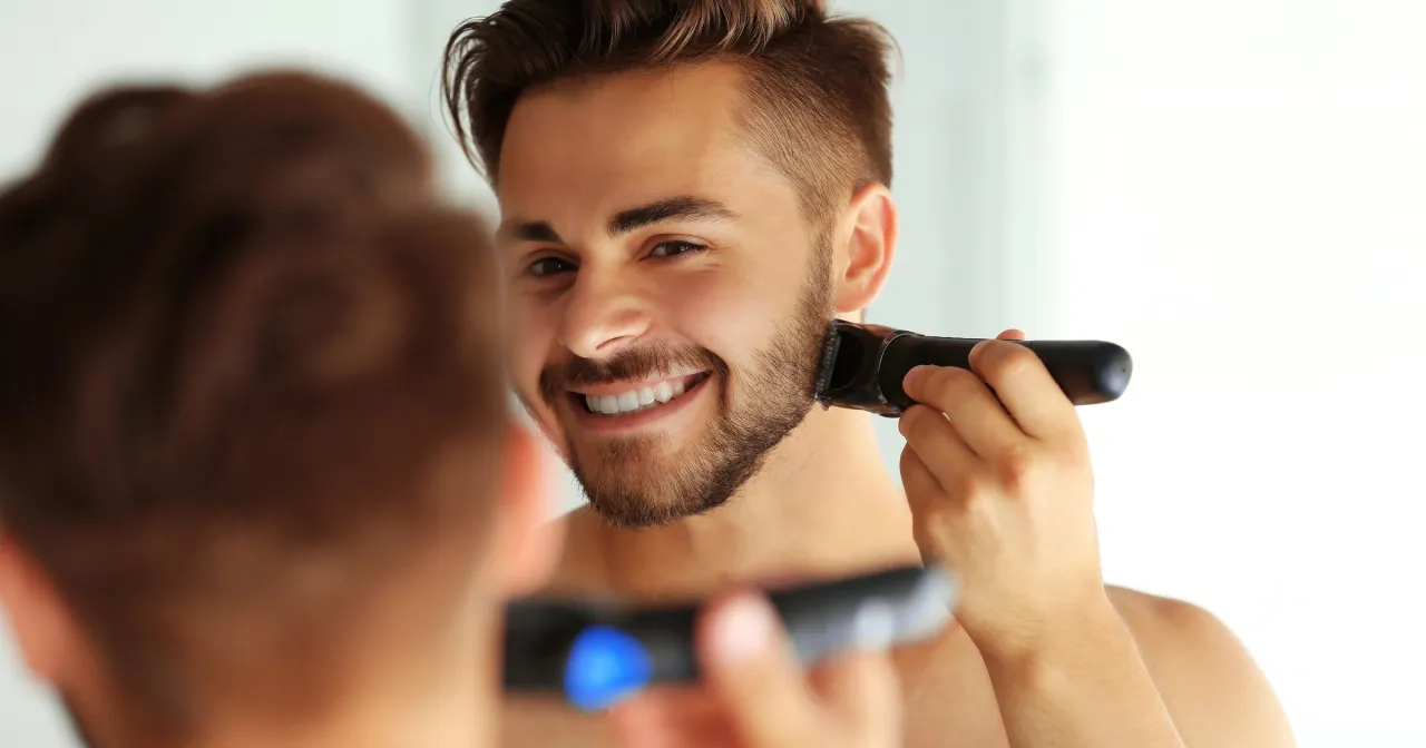 Mężczyzna używający trymera do zarostu