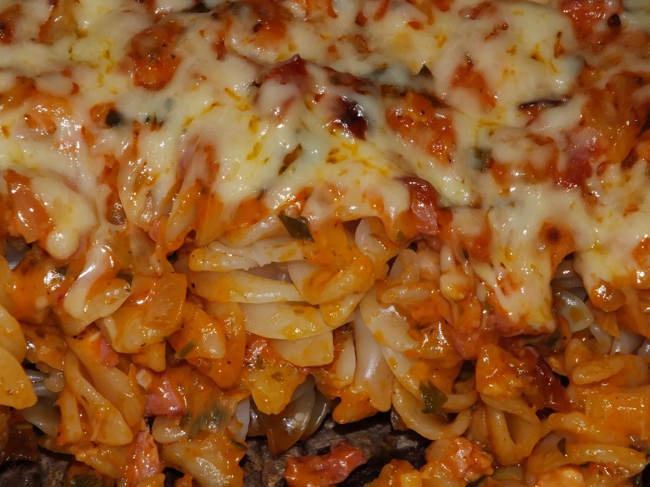 Zapiekanka makaronowa z sosem pomidorowym i ciągnącym się serem. Idealne danie, co zrobić z pomidorów na obiad.