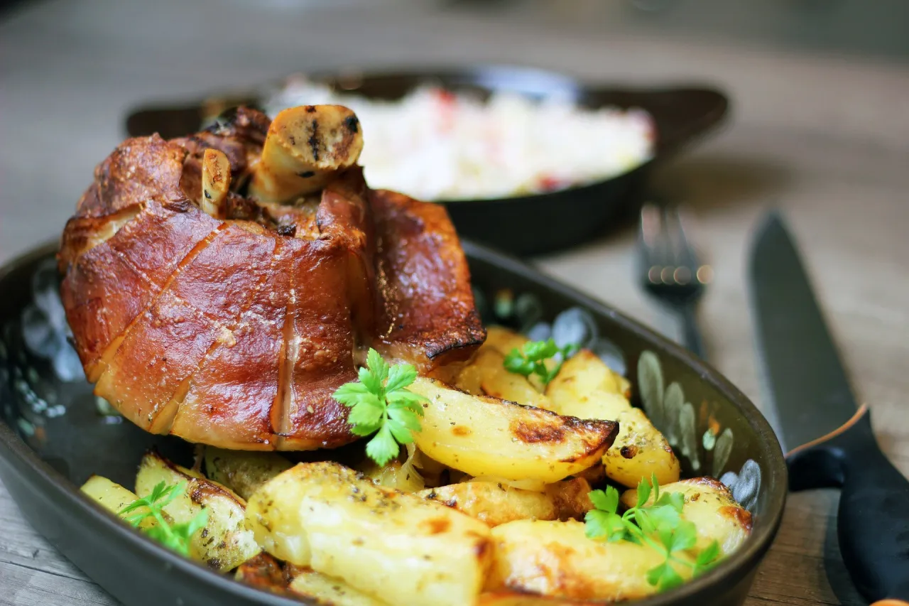 tradycyjne gotowanie golonki w garnku z warzywami