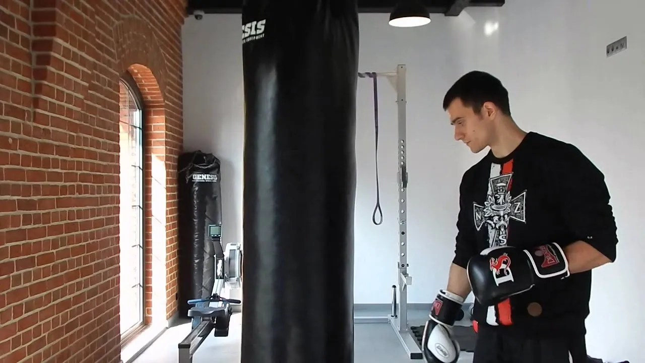 osoby trenujące w boxie crossfitowym, trener pomaga początkującemu