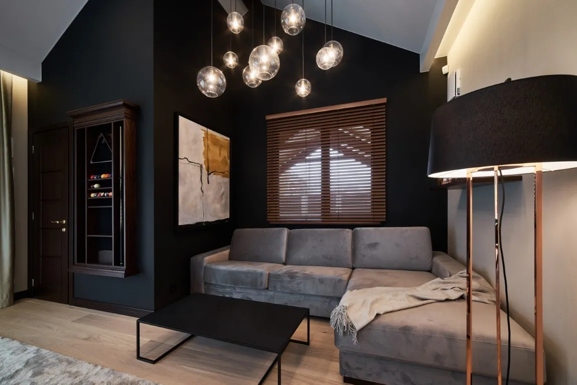 Oświetlenie wnętrza z ciemnymi meblami