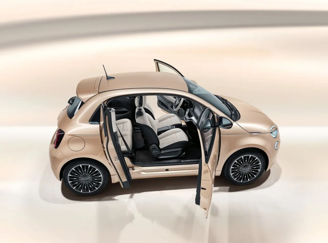 Eleganckie, małe auta dla pań w kolorze szampańskim. Wnętrze z jasnymi siedzeniami i czarnymi detalami.
