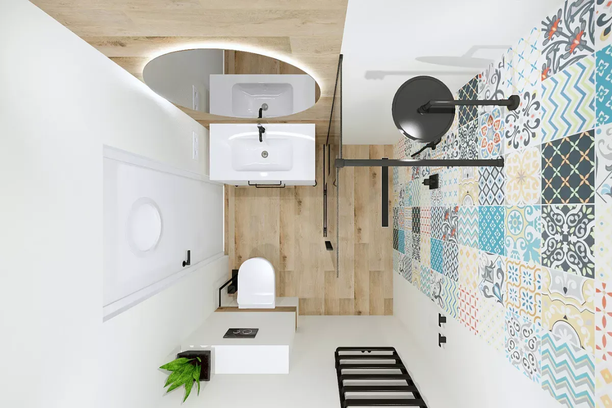 Kolorowe płytki i drewno na podłodze – inspiracja, jak wykafelkować małą łazienkę. Biała armatura, lustro i prysznic.