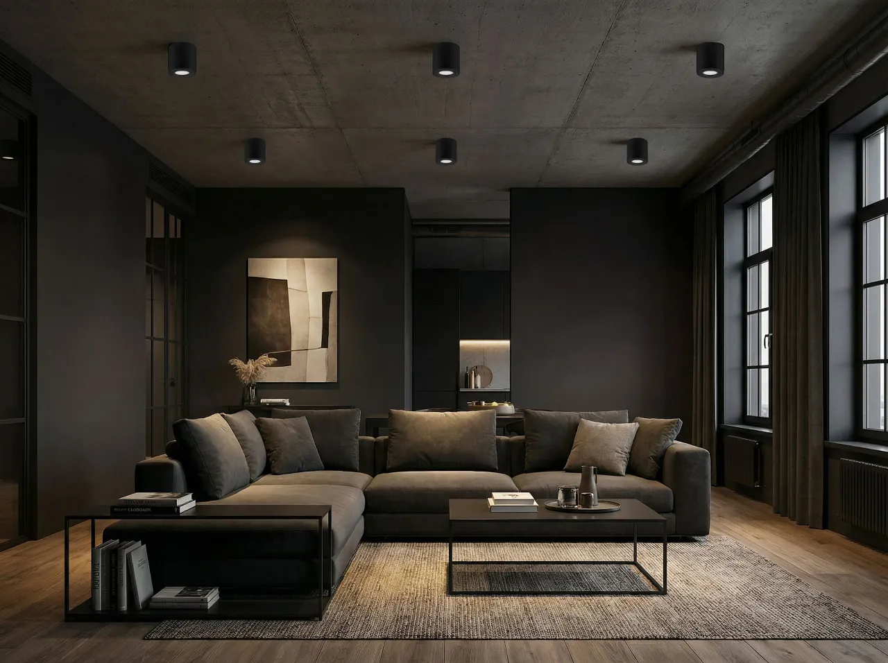 Nowoczesny salon z szarą sofą i stolikami. Na suficie widoczna jest czarna instalacja natynkowa, kt&oacute;ra subtelnie oświetla wnętrze.