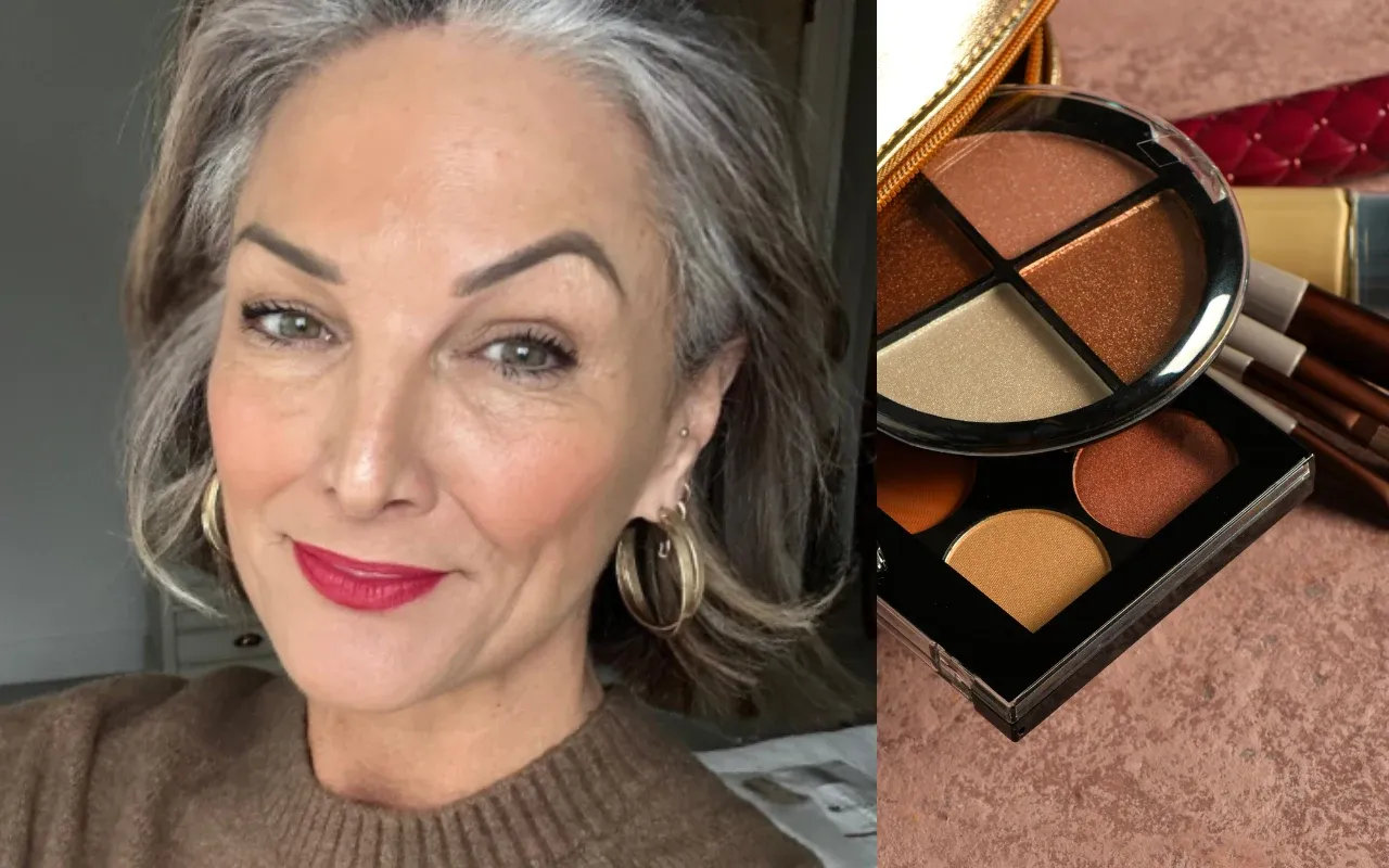 Elegancka kobieta z siwymi włosami, podkreślonymi makijażem, pokazuje palety cieni do powiek. Inspiracja, jak nosić siwe włosy z klasą.