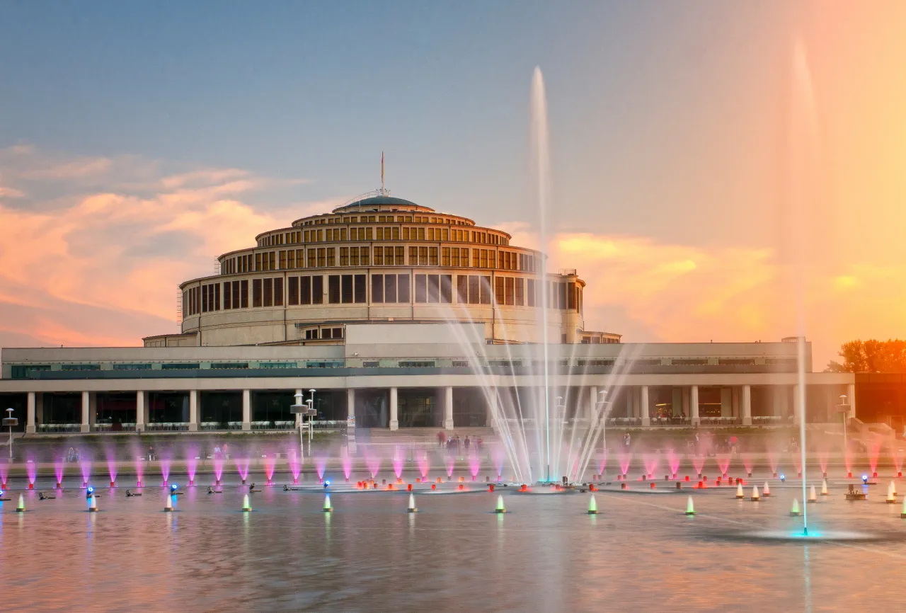 Hala Stulecia we Wrocławiu, jeden z najpiękniejszych miejsc wrocław, z pokazem fontann o zachodzie słońca.