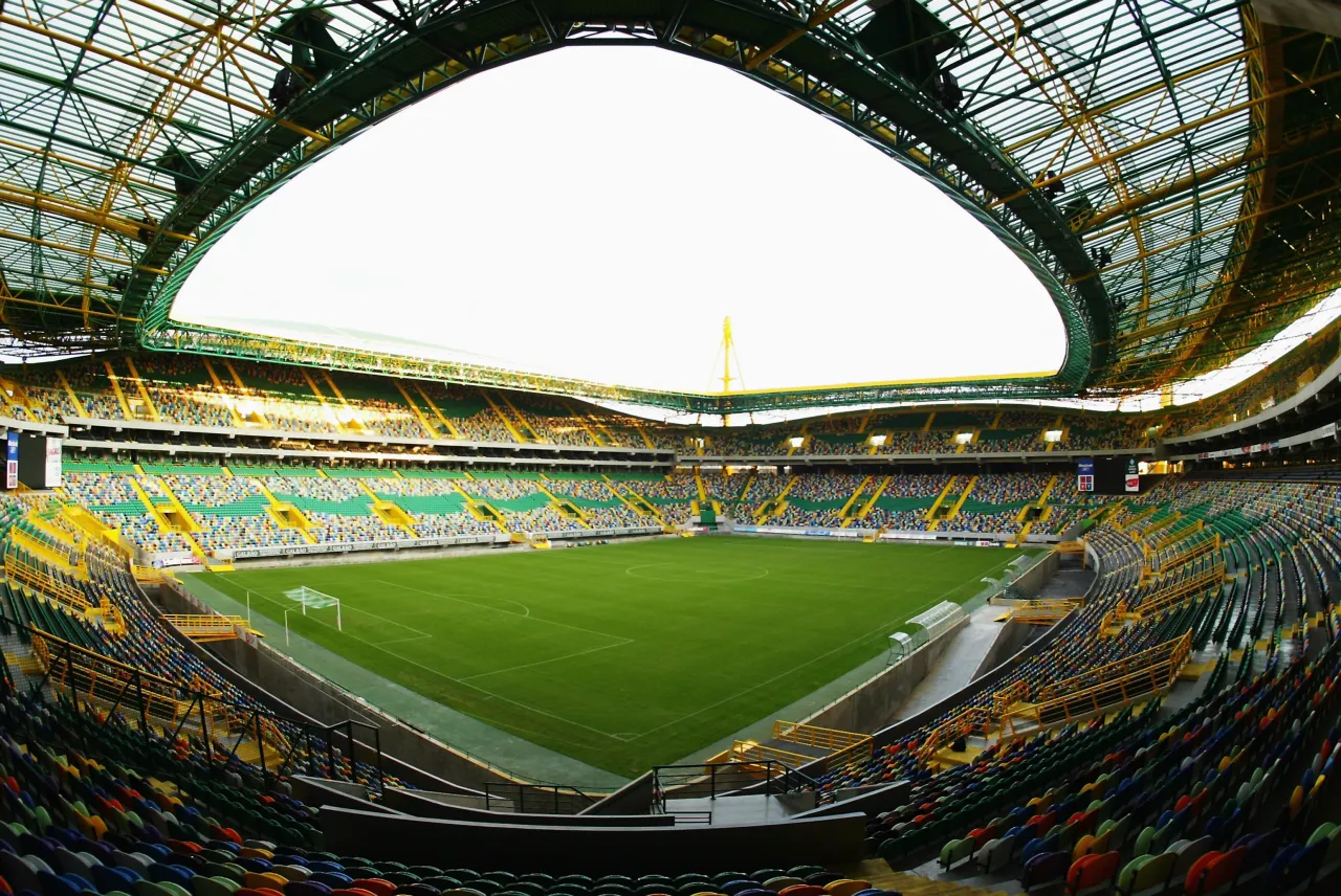 Puste trybuny stadionu, gotowe na emocje, kiedy mecze ligi mistrzów 2020. Zielono-żółta konstrukcja dachu i kolorowe siedzenia czekają na kibiców.