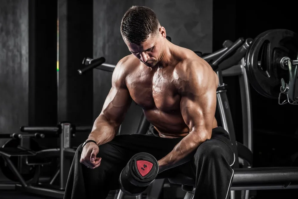 Osoba początkująca na siłowni wykonująca ćwiczenie FBW