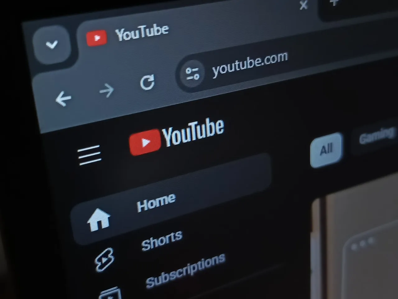 Ekran komputera pokazuje, jak otworzyć YT w przeglądarce, wpisując youtube.com. Widoczny jest interfejs strony głównej YouTube.