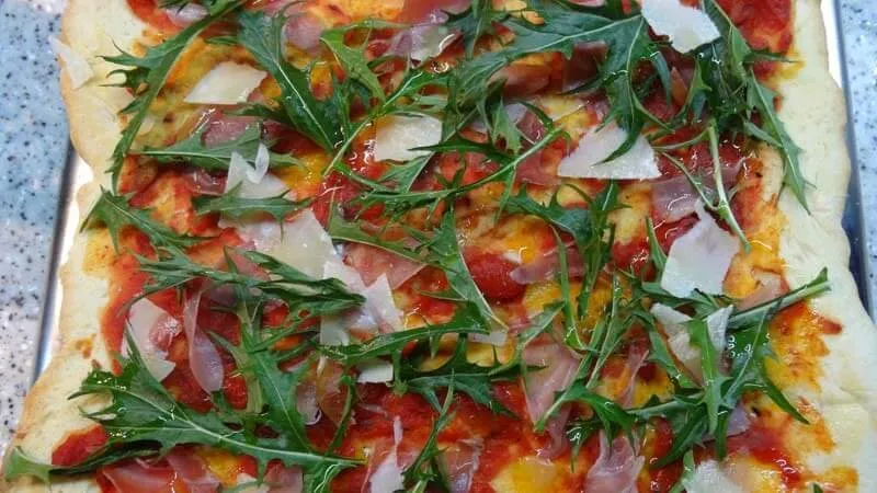 pizza z dodatkami, rukola, oliwa