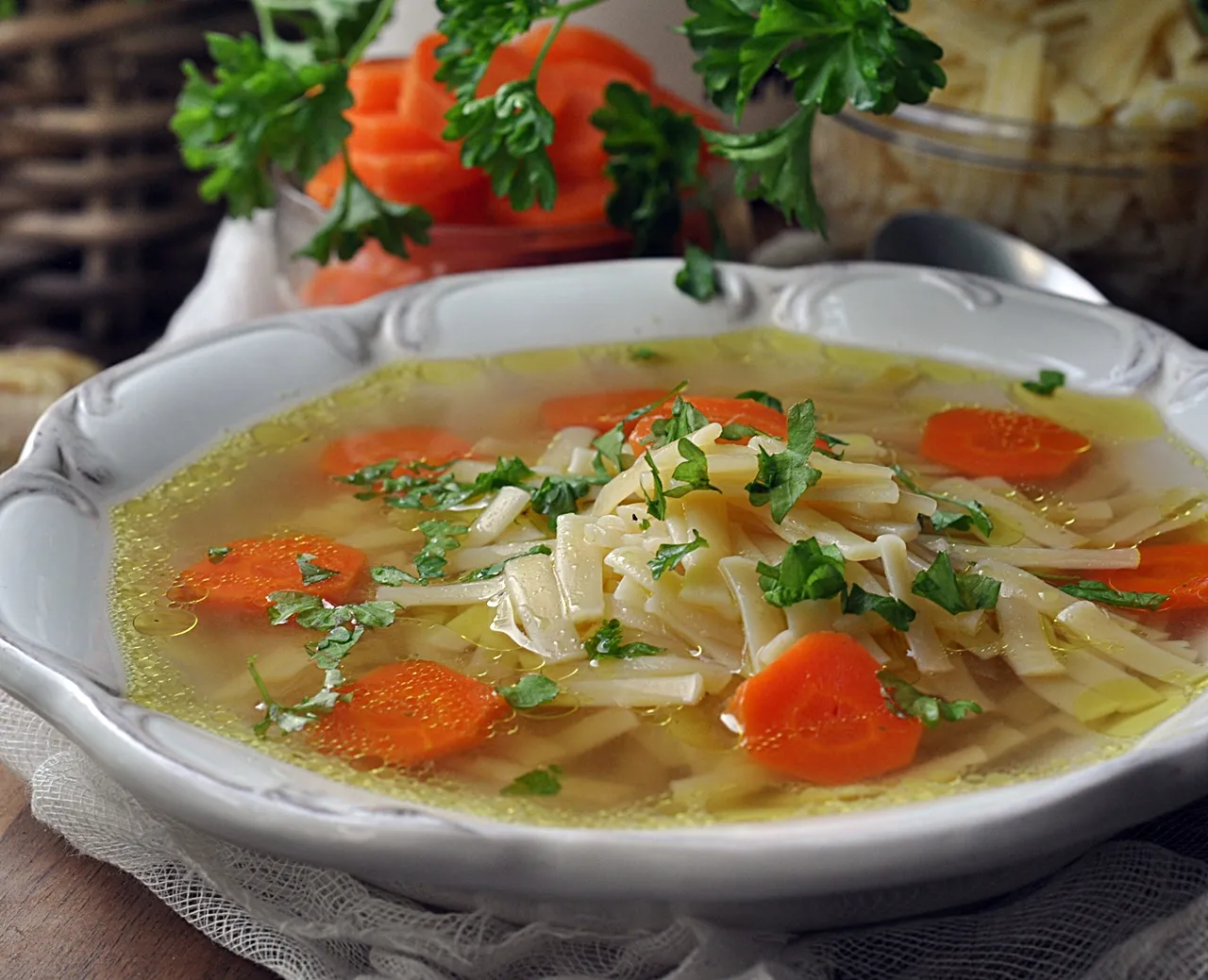 Rosół drobiowy i wołowy z makaronem na dwóch talerzach