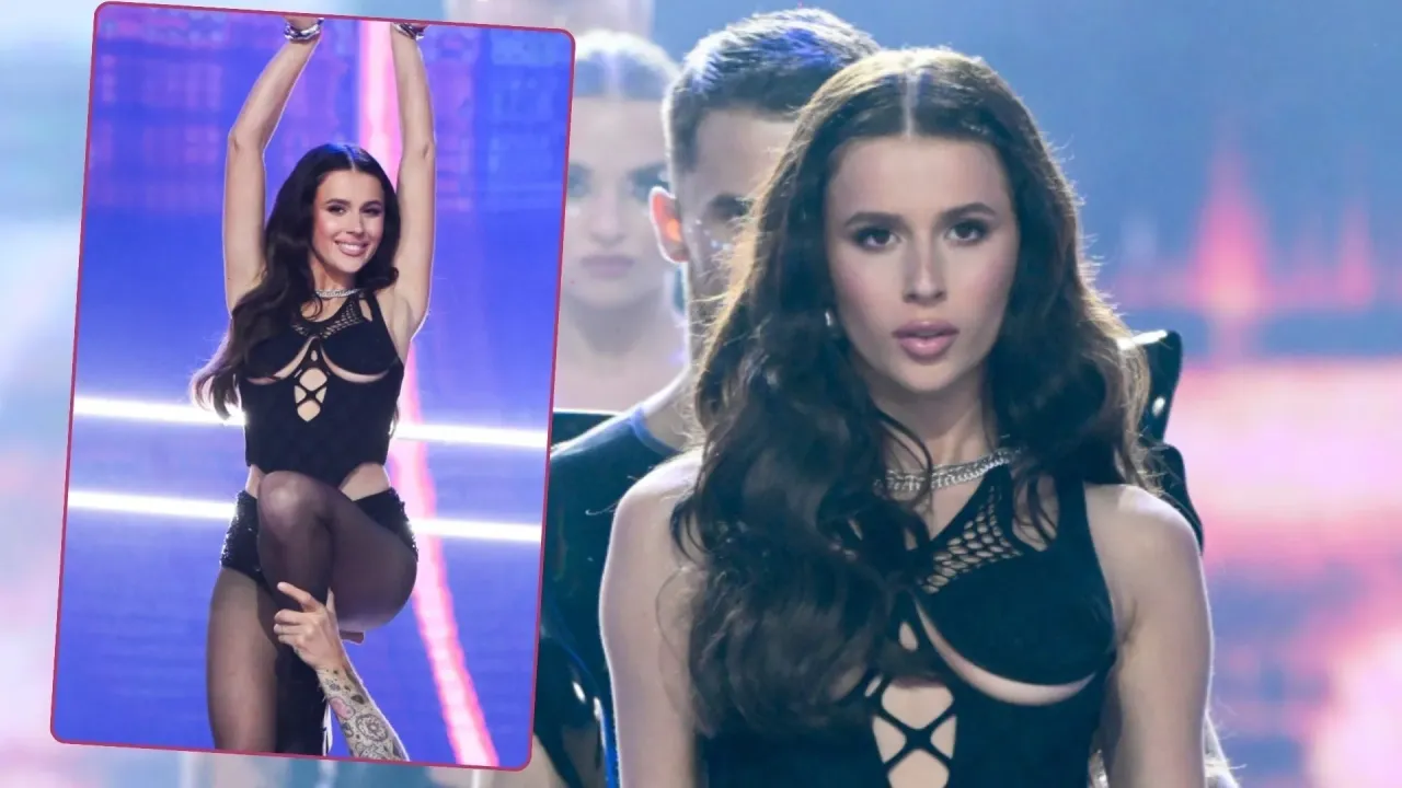 Roksana Węgiel na scenie, w czarnym, wyciętym stroju. Koncert trwa, a fani zastanawiają się, ile trwa koncert Roksany Węgiel.