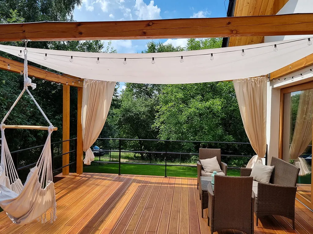 nowoczesny taras z żaglem przeciwsłonecznym