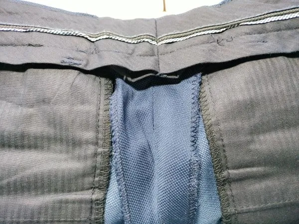 tylny szew w spodniach garniturowych z zapasem materiału