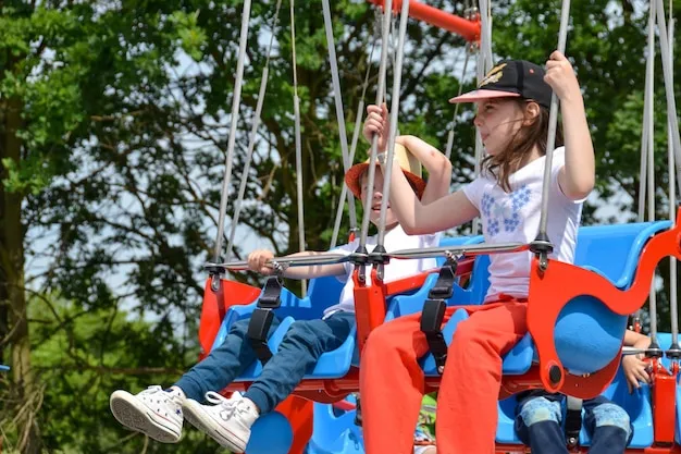 dzieci bawiące się w parku rozrywki karuzela