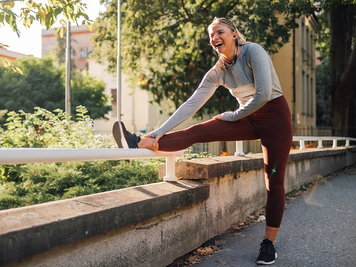 Biegaczka rozciągająca się po wieczornym biegu w parku
