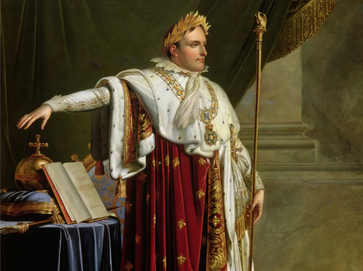 Napoleon Bonaparte w koronie laurowej i cesarskich szatach, obok Kodeksu Napoleona. Ciekawostki o Napoleonie Bonaparte.