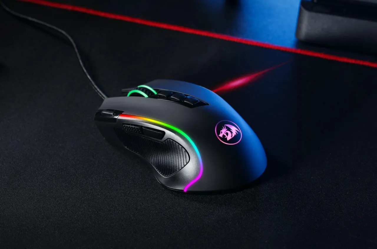 Czarna myszka gamingowa z podświetleniem RGB, jeden z wielu rodzaj&oacute;w myszek komputerowych, leży na czarnej podkładce.