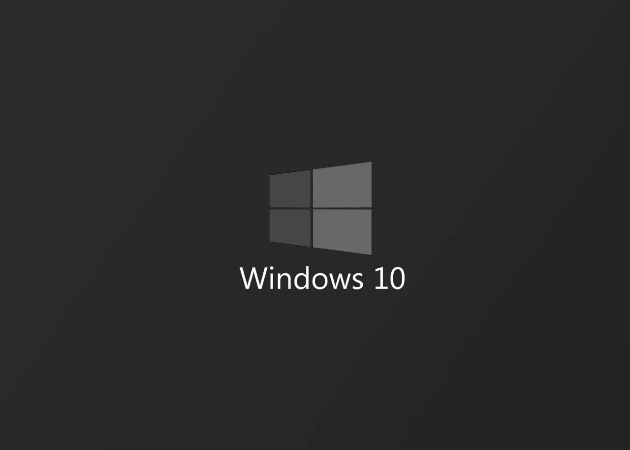 Szare logo Windows 10 na ciemnym tle. Dowiedz się, jak zaktualizować Windows 10 do 1903.