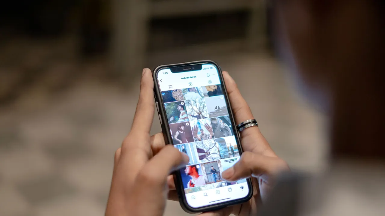 Person troubleshooting smartphone Instagram