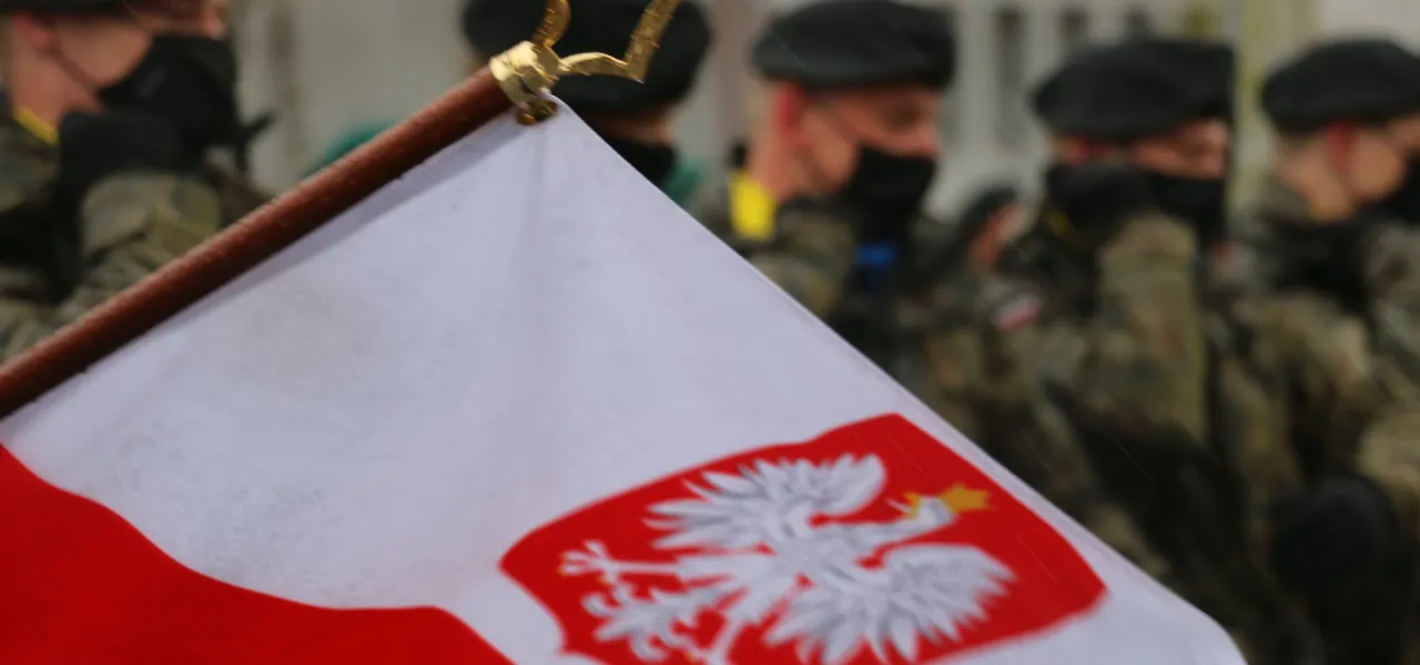 Polski żołnierz na tle flagi lub symboli narodowych