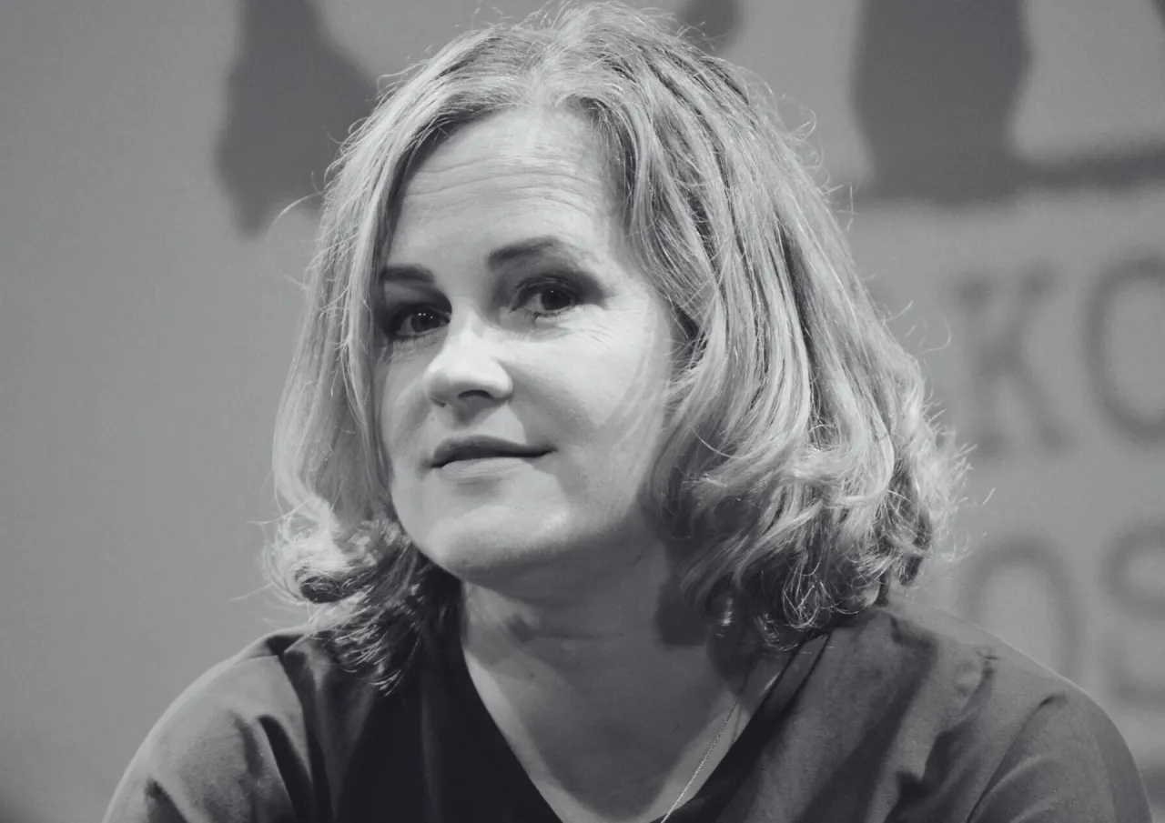 Joanna z kabaretu hrabi, z uśmiechem na twarzy, w czerni i bieli.