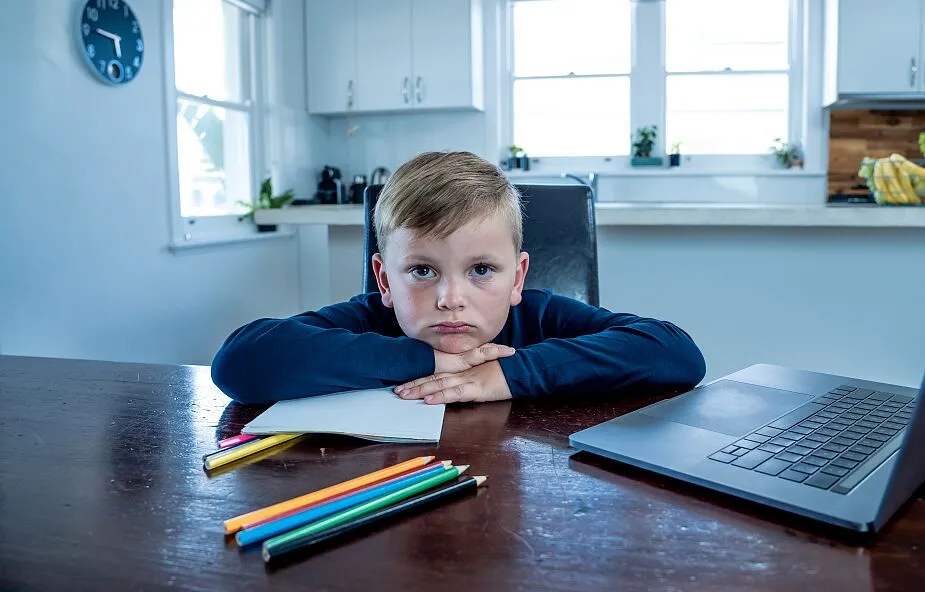 dziecko smutne przed komputerem nauka zdalna
