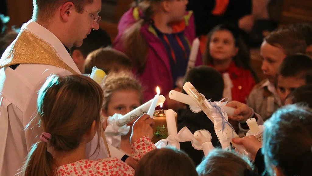 dziecko odnawia przyrzeczenia chrzcielne świeca