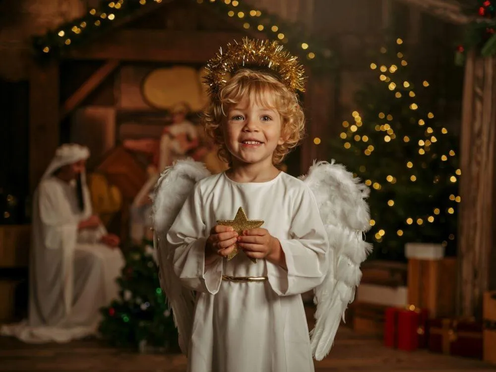 Dziecko w stroju aniołka z prześcieradła DIY